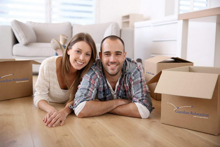 Couple on floor with moving boxes Stress Free Moving Guardian Relocation